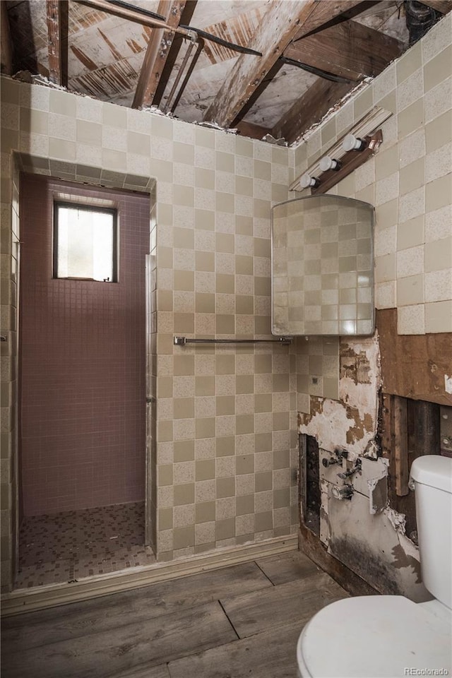 1195 Boston St, Aurora, CO 80010 - bathroom featuring toilet, wood finished floors, and a shower stall