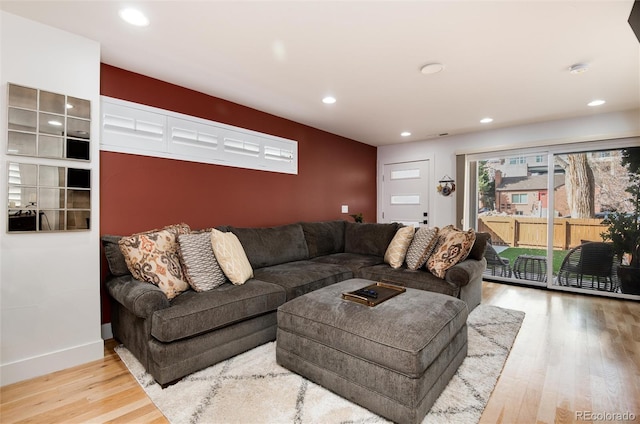 living area with recessed lighting, baseboards, and wood finished floors