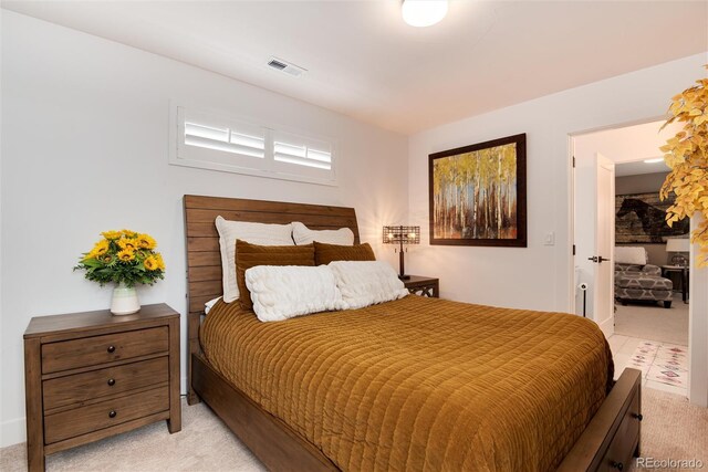 bedroom with visible vents and light colored carpet