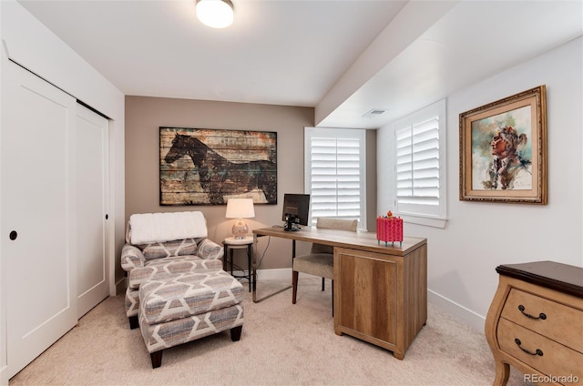 office with visible vents, light colored carpet, and baseboards