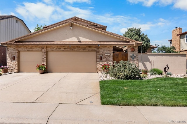 11241 E Cimmarron Dr, Englewood, CO 80111 - view of front facade featuring an attached garage, concrete driveway, a front lawn, stucco siding, and stone siding