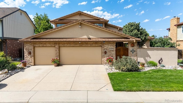 11241 E Cimmarron Dr, Englewood, CO 80111 - view of front facade with an attached garage, driveway, stucco siding, a front yard, and stone siding