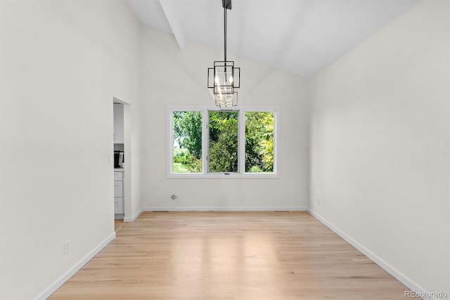 11241 E Cimmarron Dr, Englewood, CO 80111 - spare room with vaulted ceiling, light wood finished floors, and a chandelier