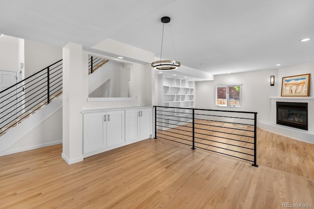 11241 E Cimmarron Dr, Englewood, CO 80111 - unfurnished living room with light wood-style floors, recessed lighting, and a glass covered fireplace