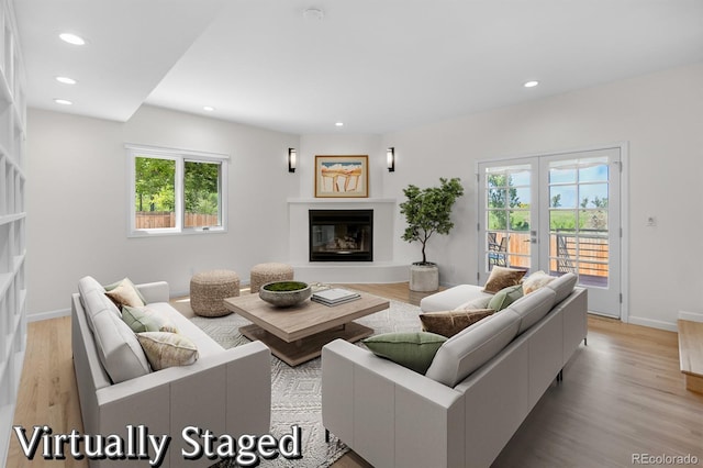 11241 E Cimmarron Dr, Englewood, CO 80111 - living room with a glass covered fireplace, healthy amount of natural light, recessed lighting, and light wood-style flooring