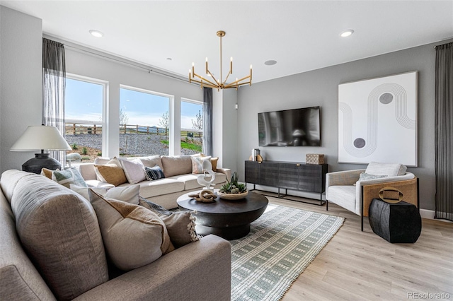 16498 W 92nd Pl, Arvada, CO 80007 - living room featuring a chandelier, light wood finished floors, and recessed lighting
