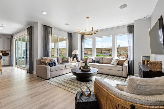 16498 W 92nd Pl, Arvada, CO 80007 - living room with light wood-type flooring, a chandelier, and recessed lighting
