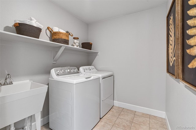16498 W 92nd Pl, Arvada, CO 80007 - washroom featuring washing machine and clothes dryer and light tile patterned floors