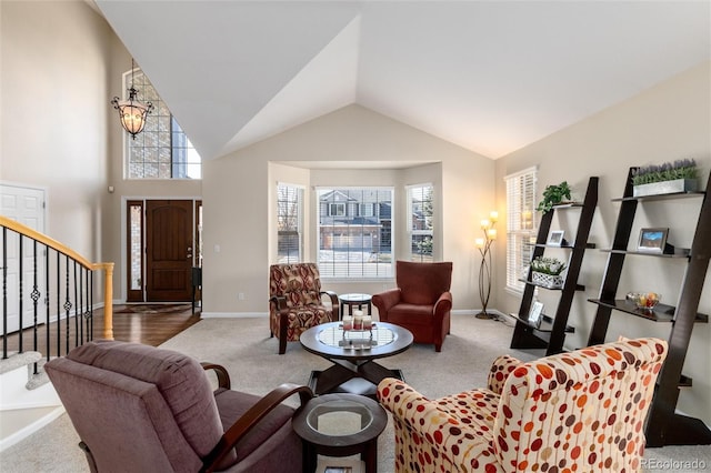 living room with carpet floors, stairway, high vaulted ceiling, and baseboards