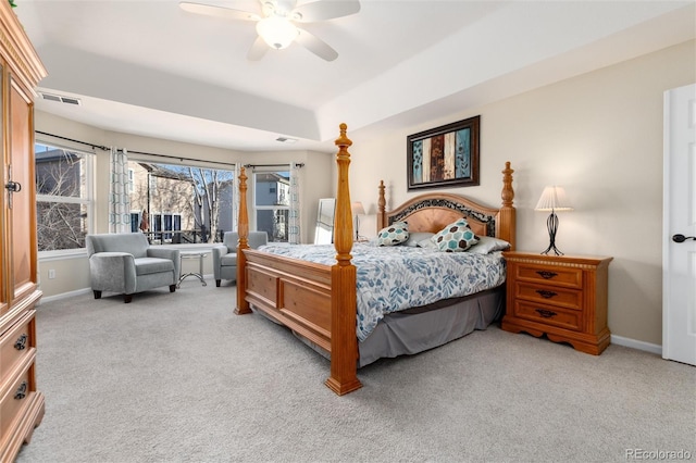 bedroom featuring baseboards, a ceiling fan, visible vents, and light colored carpet