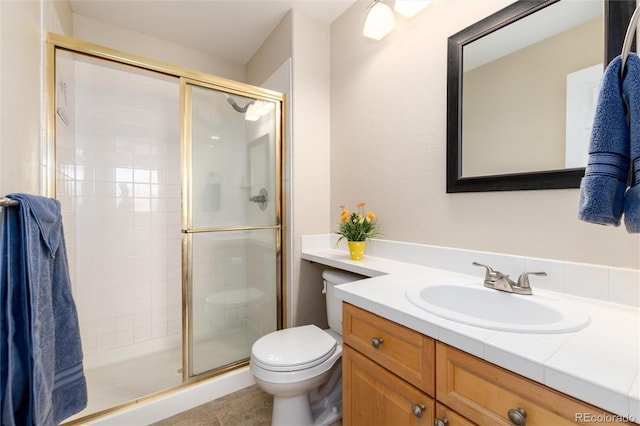 bathroom with vanity, tile patterned flooring, a shower stall, and toilet