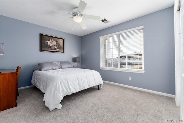 carpeted bedroom featuring ceiling fan, visible vents, and baseboards