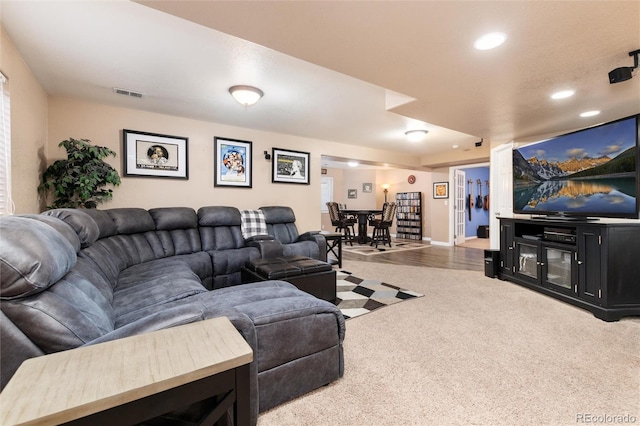 carpeted living room featuring recessed lighting, visible vents, and baseboards