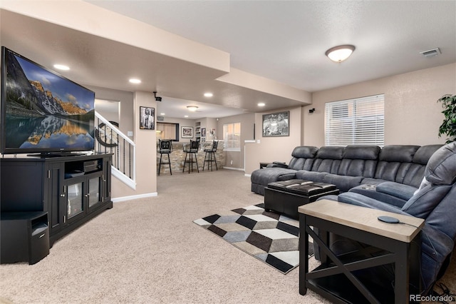 carpeted living room with visible vents, stairway, baseboards, and recessed lighting