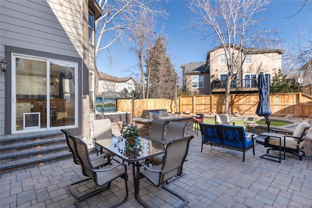 view of patio featuring outdoor dining space, a fenced backyard, and an outdoor living space