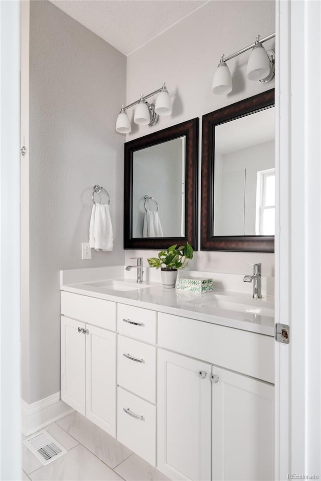 bathroom with vanity, tile patterned floors, and a textured ceiling