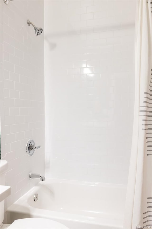 bathroom featuring shower / bath combination with curtain and toilet