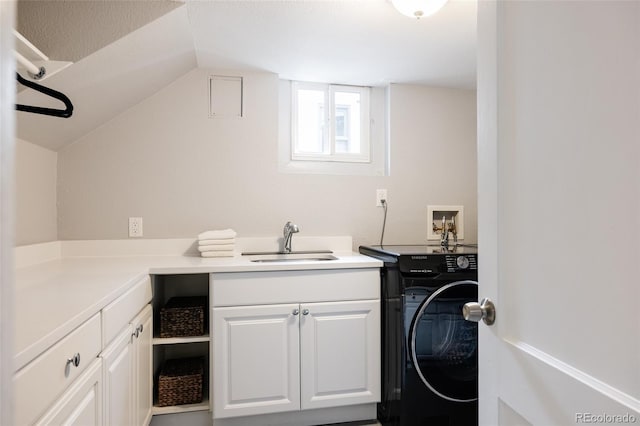 washroom with cabinets, washer / dryer, and sink