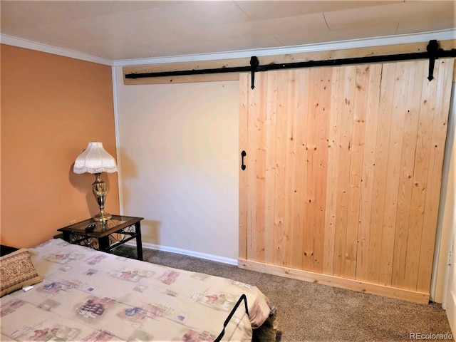 bedroom featuring a barn door, carpet floors, and ornamental molding