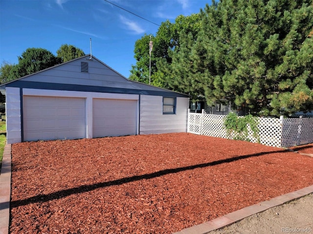 garage with fence