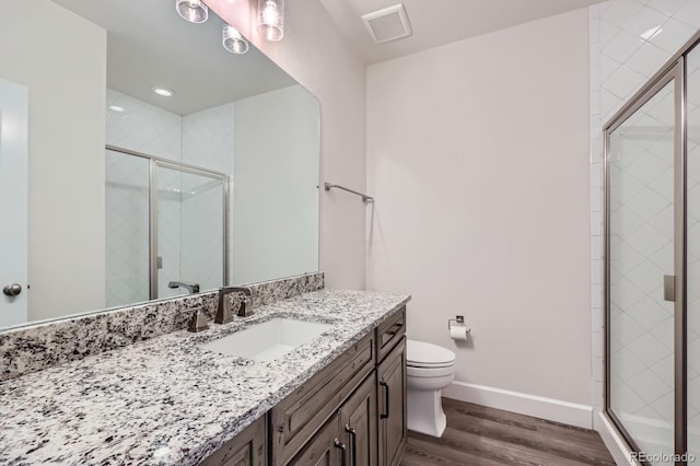 4536 Shady Path Ln, Castle Rock, CO 80104 - bathroom with wood finished floors, toilet, vanity, a shower stall, and baseboards