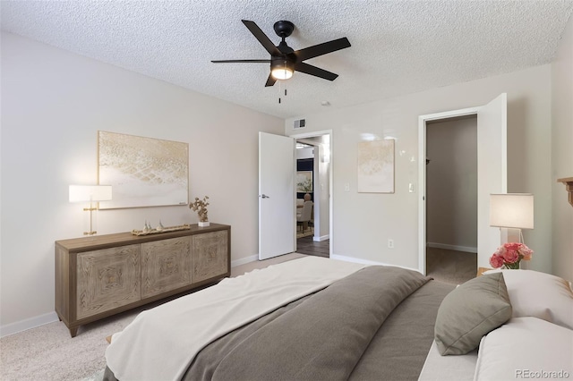 3550 S Harlan St Unit 177, Denver, CO 80235 - bedroom featuring a textured ceiling, carpet flooring, baseboards, and ceiling fan