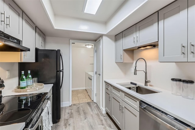 3550 S Harlan St Unit 177, Denver, CO 80235 - kitchen with appliances with stainless steel finishes, a sink, under cabinet range hood, a raised ceiling, and light countertops