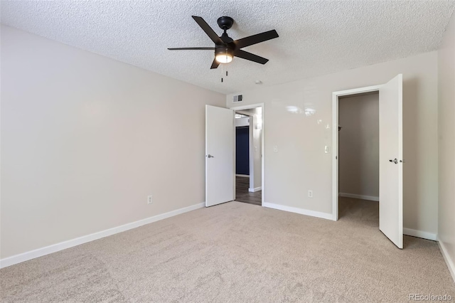 3550 S Harlan St Unit 177, Denver, CO 80235 - unfurnished bedroom featuring light carpet, a textured ceiling, baseboards, and ceiling fan