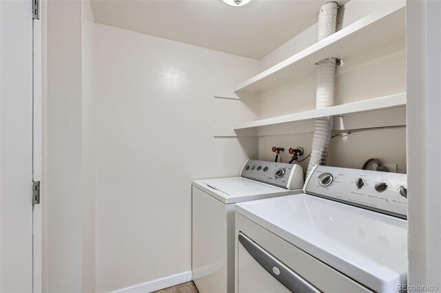 3550 S Harlan St Unit 177, Denver, CO 80235 - washroom with washer and clothes dryer and baseboards