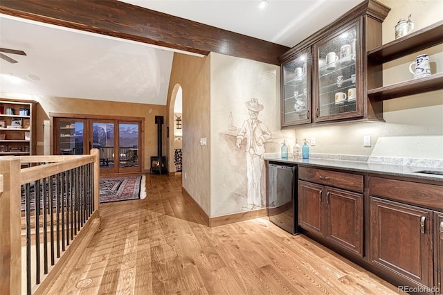 bar with stone countertops, dishwasher, light hardwood / wood-style floors, and dark brown cabinets