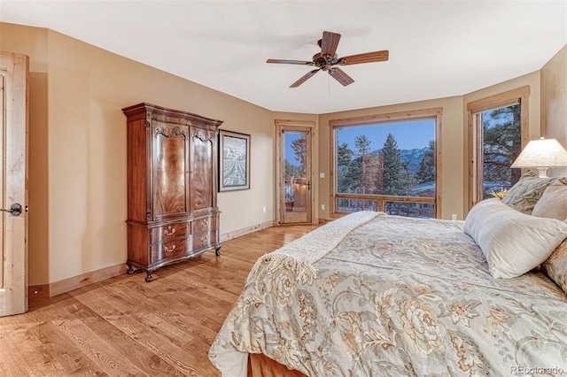 bedroom with access to outside, light hardwood / wood-style floors, and ceiling fan