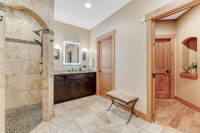 bathroom featuring vanity and a tile shower