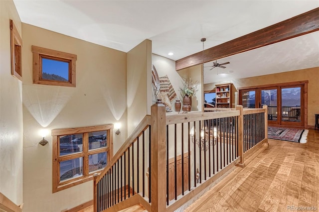 hallway with beam ceiling and light hardwood / wood-style flooring