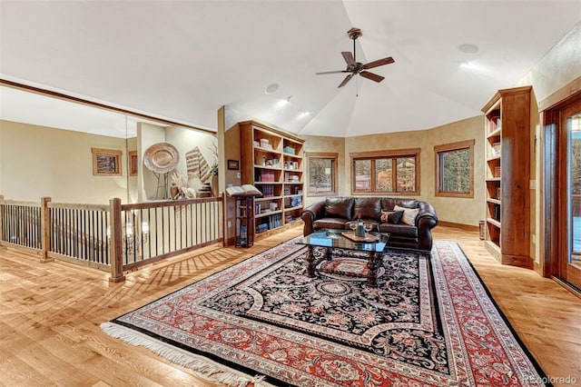 living room featuring vaulted ceiling, ceiling fan, a healthy amount of sunlight, and light hardwood / wood-style floors