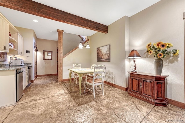 dining room with a notable chandelier, decorative columns, sink, and beamed ceiling