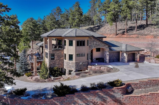 prairie-style house with a garage and a balcony