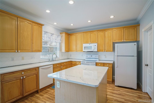 kitchen with sink, a center island, light hardwood / wood-style floors, light stone countertops, and white appliances