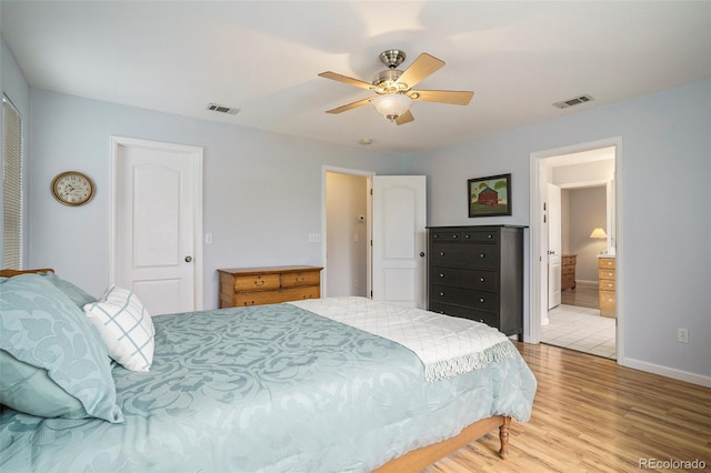 bedroom featuring hardwood / wood-style flooring, ceiling fan, and ensuite bathroom