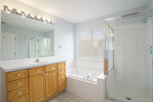 bathroom featuring vanity, tile patterned floors, and separate shower and tub