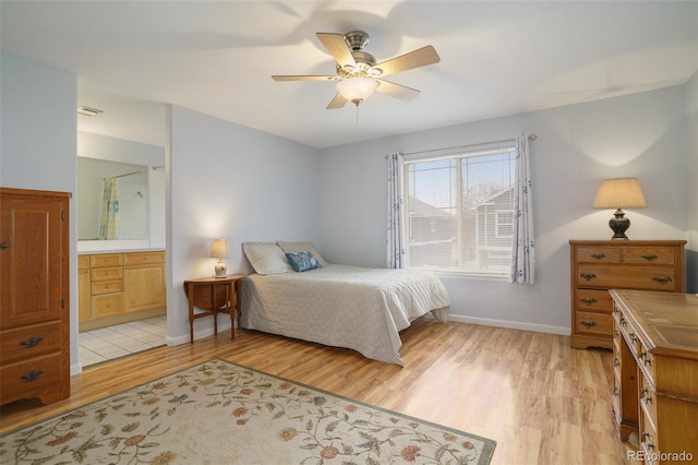 bedroom with connected bathroom, light hardwood / wood-style floors, and ceiling fan