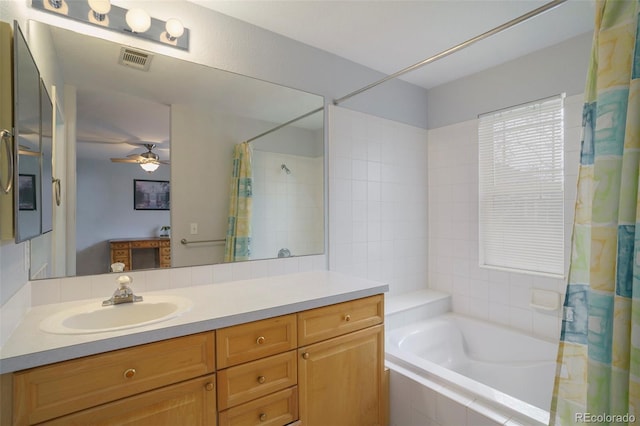 bathroom with vanity, ceiling fan, and shower / bath combo with shower curtain