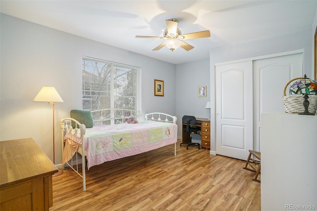 bedroom with ceiling fan, light hardwood / wood-style floors, and a closet