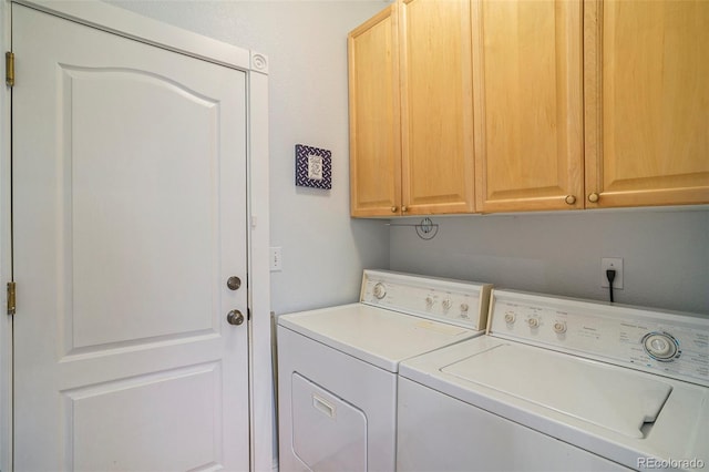 washroom with cabinets and independent washer and dryer