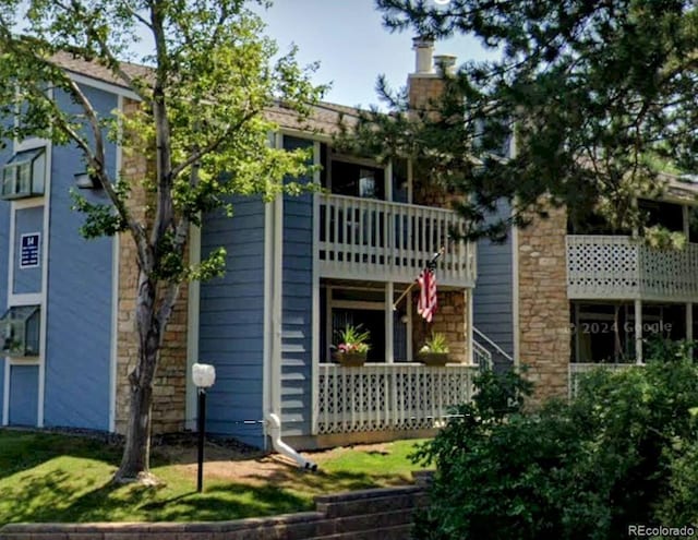 exterior space featuring a balcony and a chimney