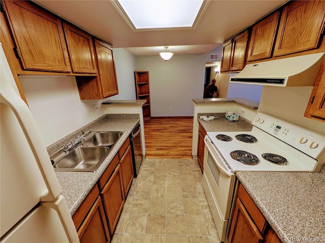 kitchen with white appliances, brown cabinets, extractor fan, and a sink
