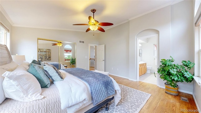 1229 Berganot Trl, Castle Pines, CO 80108 - bedroom with light wood-style floors, crown molding, a ceiling fan, ensuite bath, and baseboards