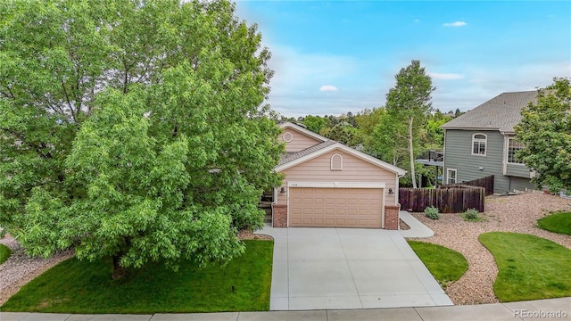 1229 Berganot Trl, Castle Pines, CO 80108 - view of front of home with brick siding, an attached garage, and driveway