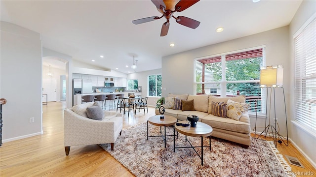 1229 Berganot Trl, Castle Pines, CO 80108 - living area featuring healthy amount of natural light, light wood-type flooring, recessed lighting, ceiling fan, and arched walkways