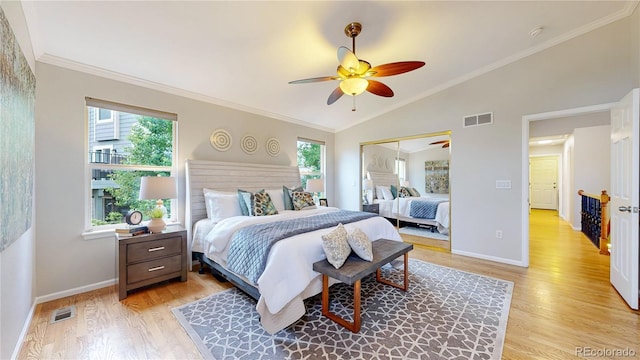 1229 Berganot Trl, Castle Pines, CO 80108 - bedroom with light wood-type flooring, multiple windows, vaulted ceiling, baseboards, and a ceiling fan
