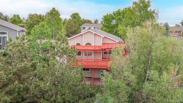 1229 Berganot Trl, Castle Pines, CO 80108 - rear view of property featuring a wooden deck